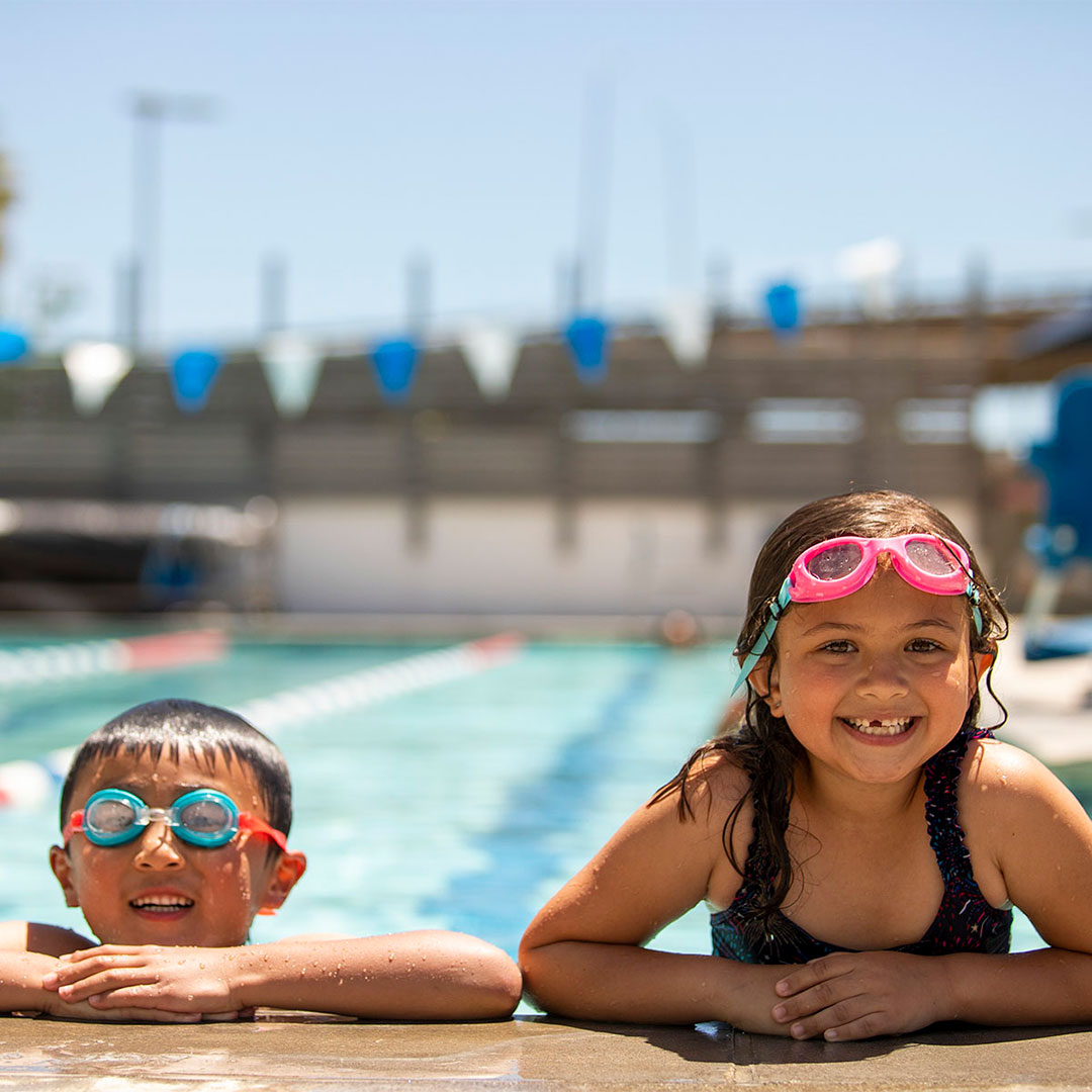 Two children on the edge of a pool