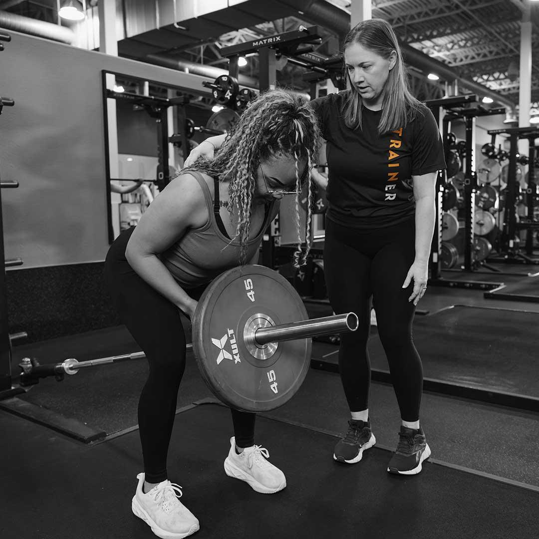 woman squatting with a barbell