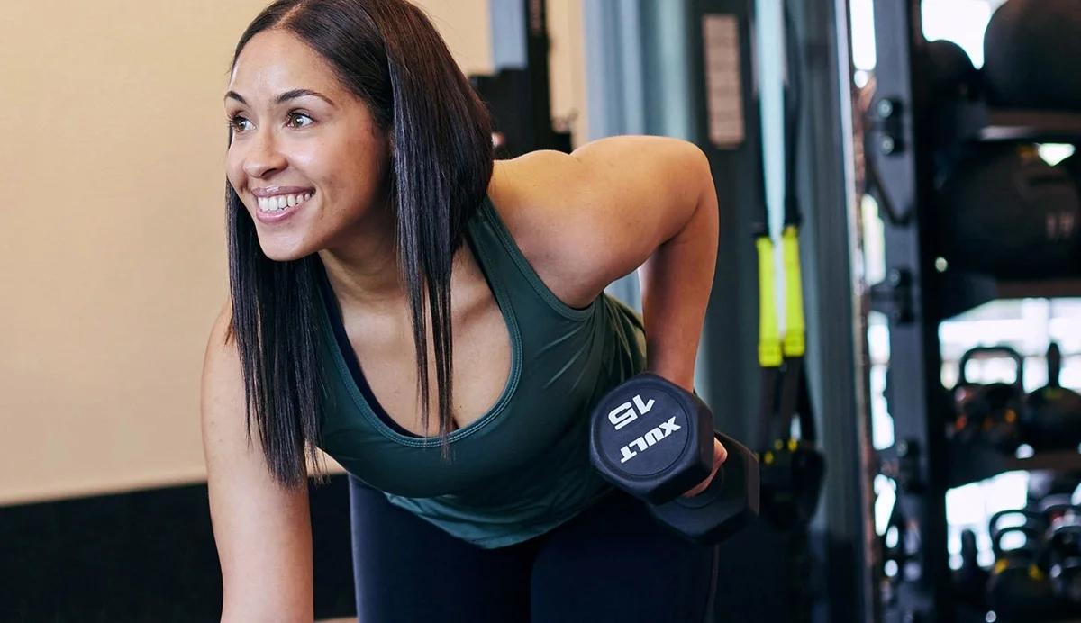 woman lifting dumbbell in a row