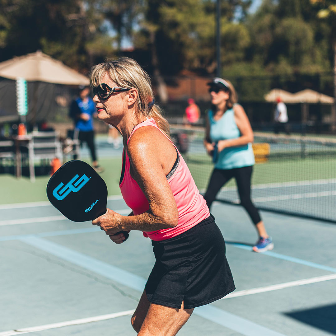 Woman playing pickleball outdoors