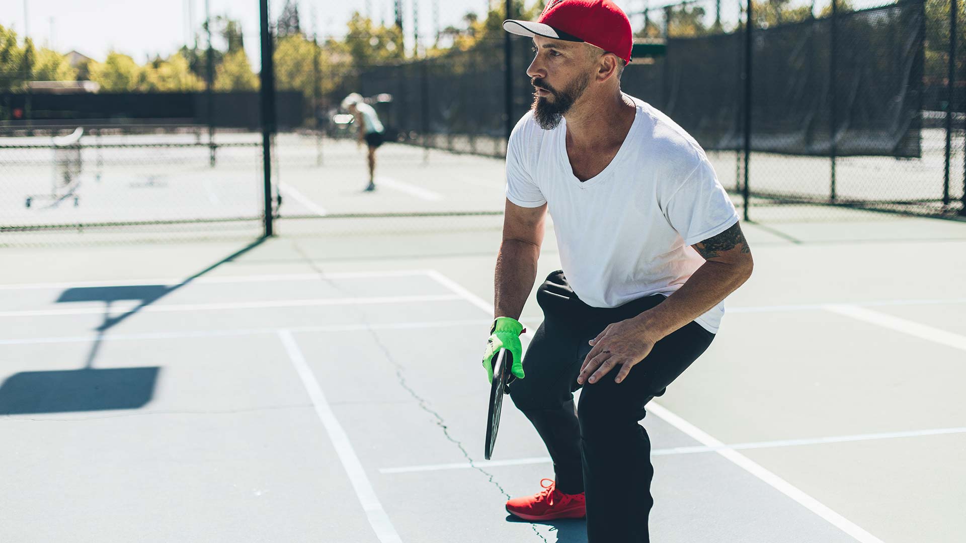 man playing pickleball outdoors