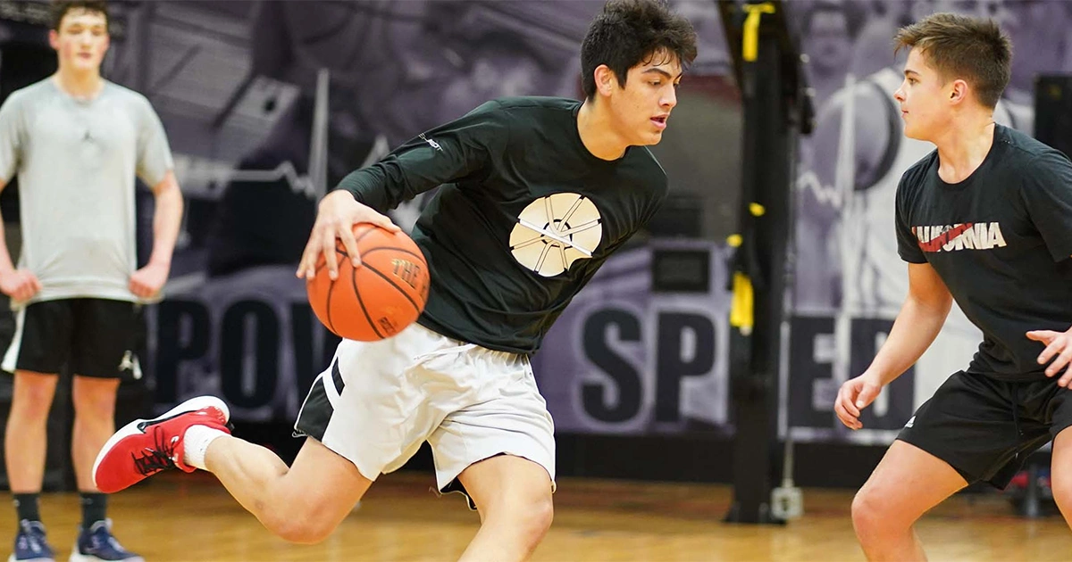 two teenagers playing basketball